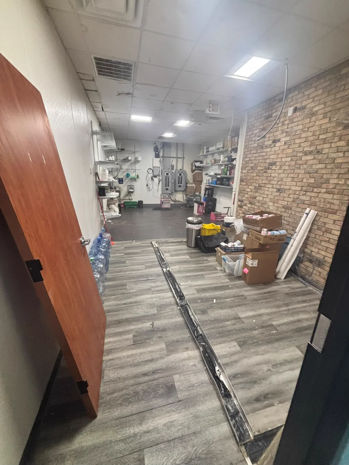Rear stockroom with boxes and supplies before the cleanout